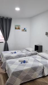 two beds sitting next to each other in a bedroom at Hostal Vara Madrid in Madrid