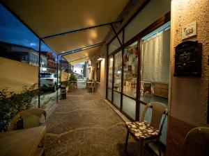 a walkway in a building with a table and a chair at Albergo Ristorante Locanda Rosella in Giba