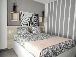 a bedroom with a bed with a zebra headboard at Las Palmas Golf & Beach in Las Palmas de Gran Canaria