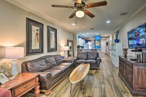 a living room with a couch and a ceiling fan at Waterfront Condo with Boat Dock, Gym and Pool! in Palm Coast