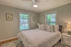 a bedroom with a white bed and two windows at The Lake Escape Boat Dock, Paddle Board, Kayak! 