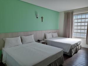 מיטה או מיטות בחדר ב-CEIC Pousada e Eventos