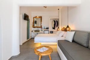 a living room with a bed and a couch at Casa Anna Suites in Mikonos