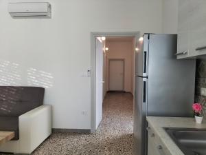 a kitchen with a refrigerator and a hallway at Casa vacanza da Flavia in Acquarica del Capo