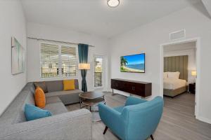 a living room with a couch and chairs and a bed at Newly Renovated Condo wFREE Resort Access in Orlando