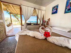 a bedroom with a bed with a flower in the middle at Hotel Punta Ballenas in Máncora +81 photos