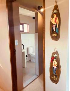 a bathroom with a mirror and a towel hanging on the wall at Loft Canoa in Aracati