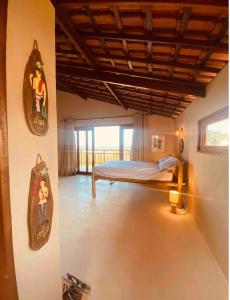 a room with a bed in the middle of a room at Loft Canoa in Aracati