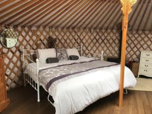 a bedroom with a bed in a yurt at Buzzard Holt Hosting in Buckingham