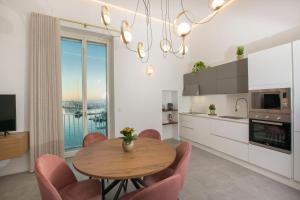 a kitchen and dining room with a table and chairs at Residenza Rebecca in Trani