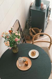 a green table with a vase of flowers on it at Fejny Dom - Jezioro Dadaj in Kromerowo +23 photos