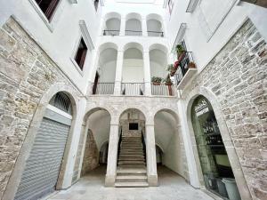 a hallway of a building with stairs and a balcony at Residenza Rebecca in Trani