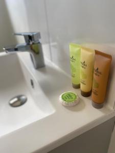 a bathroom counter with two bottles of soap and a sink at Buzzard Holt Hosting in Buckingham