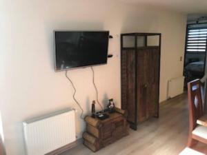 a living room with a flat screen tv on a wall at Departamento Nuevo en Condominio Costa Pucon in Pucón