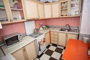 a small kitchen with a stove and a sink at Hostel California in Batumi