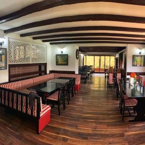 a restaurant with red chairs and a table in a room at Teuta Palace Dom Faletići in Sarajevo