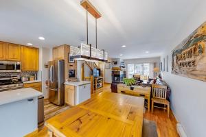 a kitchen with a wooden table and a dining room at Saw Mill Station 127 in Winter Park