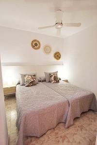 1 dormitorio con 1 cama con 2 platos en la pared en APN Apartamento Playa de Guardamar, en Guardamar del Segura
