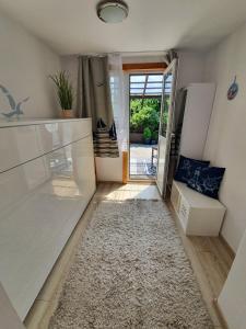 a hallway with a door leading to a patio at Słonecznik Jastarnia. Domek na Zdrojowej. in Jastarnia