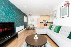 a living room with a white couch and a tv at Granville Street - Spacious 2 Bedroom Apartment Birmingham City Centre in Birmingham