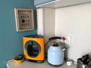 a kitchen counter with a coffee maker and a tea kettle at Studio N in Primorsko