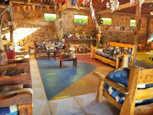 a living room with couches and tables in a building at Aconchego no Campo in São Roque
