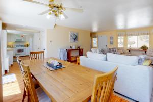 a dining room and living room with a wooden table at Tree-Top Getaway in Lake Arrowhead