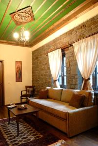 a living room with a couch and a table at Adrasteia Guesthouse in Negades