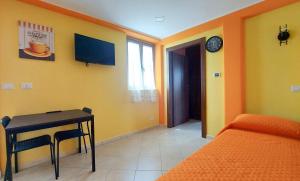 a room with a desk and a bed and a table at CORSO MARCONI HOUSE in Civitavecchia