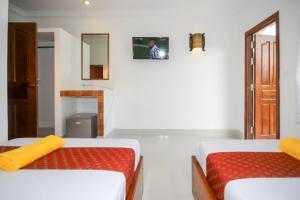 a room with two beds and a mirror at Blossoming Romduol Boutique in Siem Reap