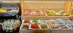 a refrigerator filled with lots of different types of food at Hotel Alttolkewitzer Hof in Dresden