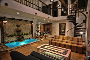 a large living room with a pool in the middle of it at Casa Del Reloj in Medellín