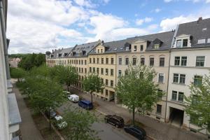 a large building with cars parked in front of it at FullHouse - Chemnitz - Z25 Apartments - 3 Beds - SmartTV - Nespresso in Chemnitz