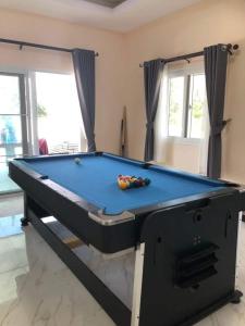 a pool table in the middle of a room with a pool at Ranch Seda Mosegaard in Amphoe Khukhan