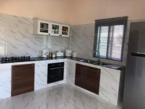a kitchen with white marble counter tops and a sink at Ranch Seda Mosegaard in Amphoe Khukhan