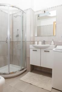 a bathroom with a shower and a sink at La Collina sul Mare Apartments in Petacciato +28 photos