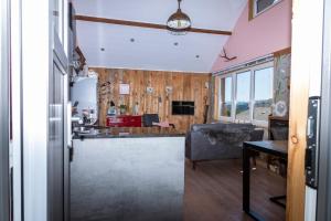 a kitchen and living room with a couch and a table at Le Petit Moussis in Stavelot