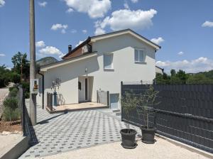 a white house with a black fence at Villa Longina in Ljubuški