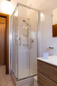 a shower with a glass door in a bathroom at Smart and Sea in Tortoreto Lido +37 photos