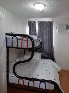a bedroom with two bunk beds in a room at Lovely 2 BR Condo with FREE Secured Parking in Manila +6 photos
