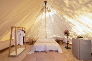 a bedroom with a tent with a bed in it at Camping Chania in Kato Daratso