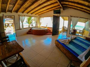 a large room with a bed and a living room at Hotel Punta Ballenas in Máncora
