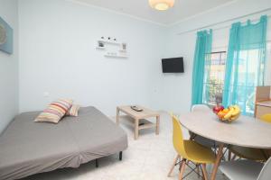 a bedroom with a bed and a table with a bowl of fruit at Blue Deluxe Apartment in Kallithea Halkidikis
