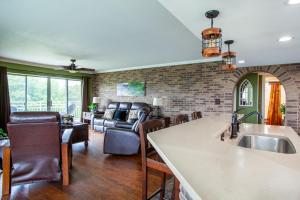 a kitchen and living room with a sink and a couch at Penthouse Paradise - Fireplace and Mountain View in Pigeon Forge