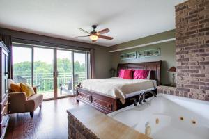 a bedroom with a bed and a bath tub at Penthouse Paradise - Fireplace and Mountain View in Pigeon Forge