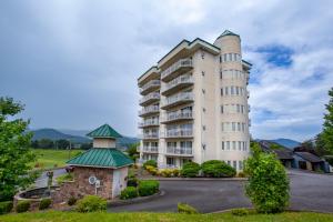 a large white building with a green roof at Penthouse Paradise - Fireplace and Mountain View in Pigeon Forge