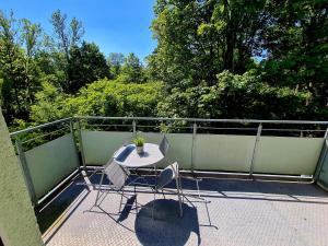 a table and two chairs on a balcony at Apartment am Gradierbau Bad Kissingen in Bad Kissingen
