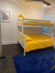 a bedroom with two bunk beds and a blue rug at Cozy 2-bedroom Farmhouse with parking on premise in Smyrna