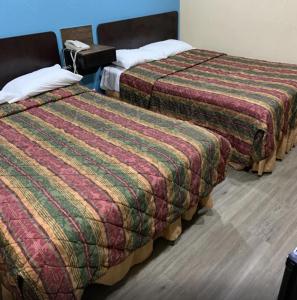 Postel nebo postele na pokoji v ubytování Royal Relax Inn