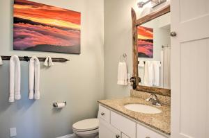 a bathroom with a sink and a mirror at Grand Chalet with Hot Tub - Near Wintergreen Resort in Wintergreen +38 photos
